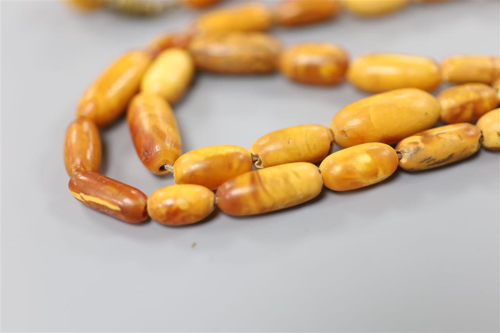 Two Chinese single strand amber necklaces.